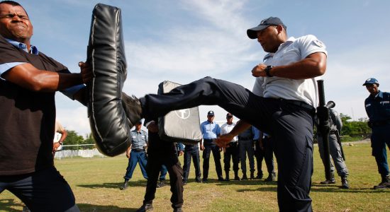 Standardization of training with major private security companies with assistance of French cooperation funded by EU.- French Police trainer seen here with private security company staff during a drill in Dili. UNMIT/ Martine Perret 2 December 2010.